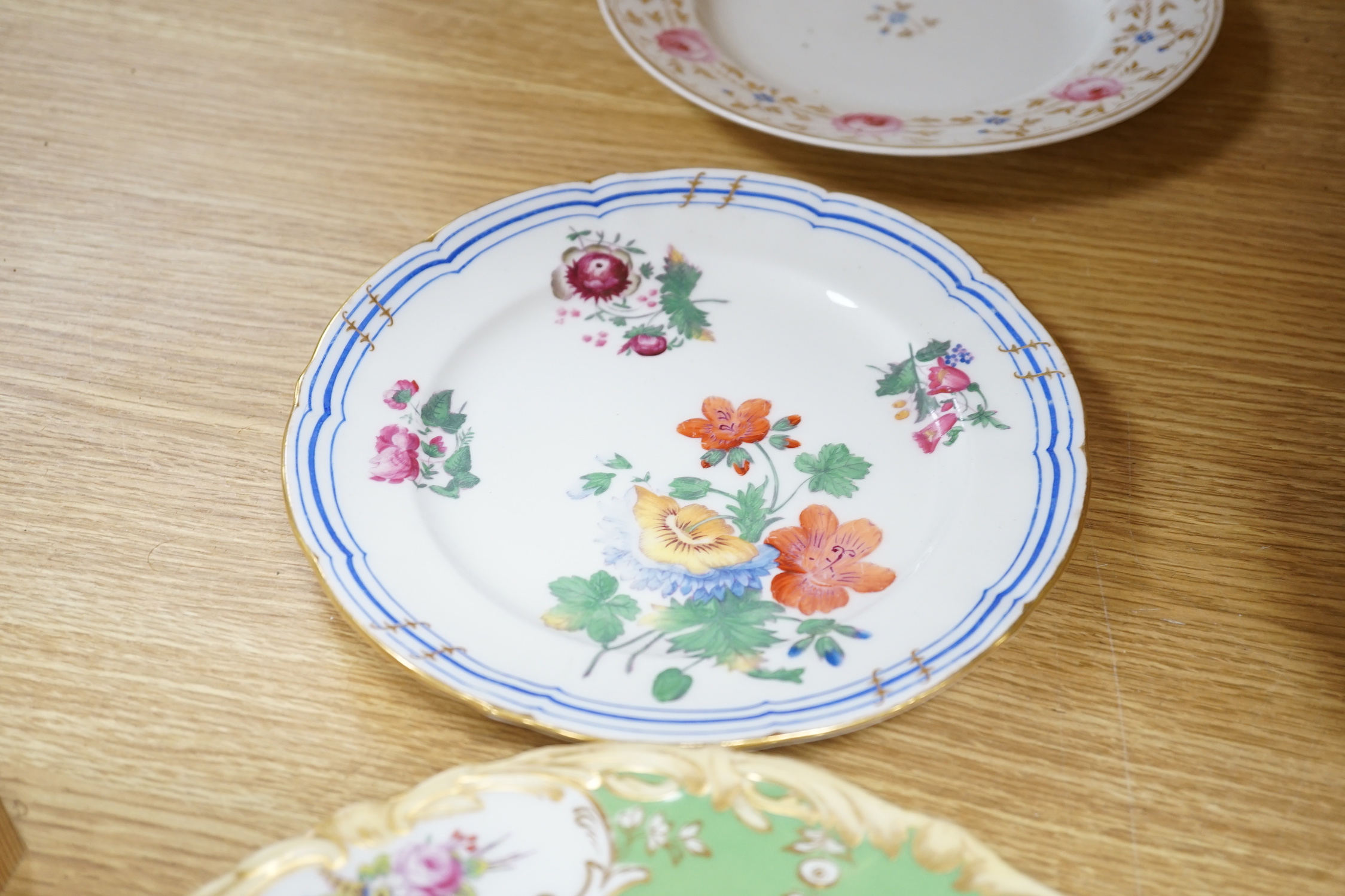 A collection of early 19th century decorative porcelain painted with flowers and a gilt blue ground plus other (12)